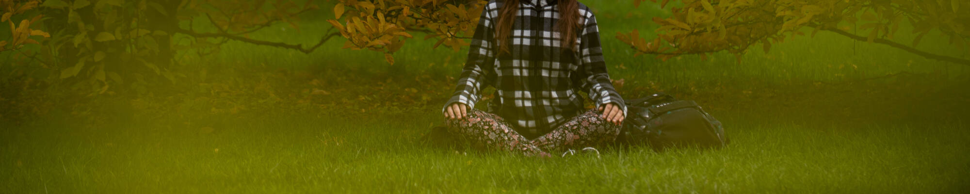 Grand Valley State University student, Alena Kupres, meditates in the arboretum November 10. Kupres, a senior studying Spanish and ESL education, said she started mediating in the beginning of the pandemic.
